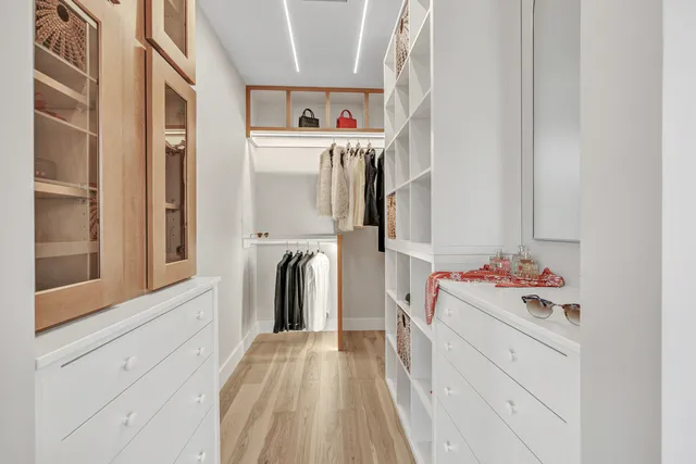 a bathroom with a double vanity sink mirror and bathtub