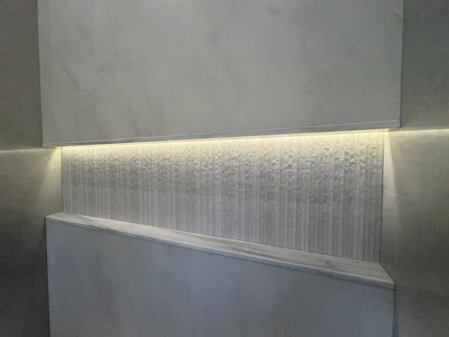 a bathroom with a granite countertop sink and mirror