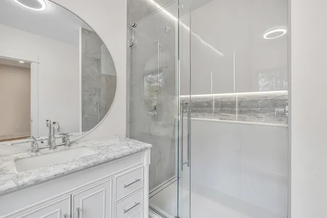 a bathroom with a granite countertop sink mirror and vanity
