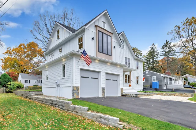 a front view of a house with a yard and garage