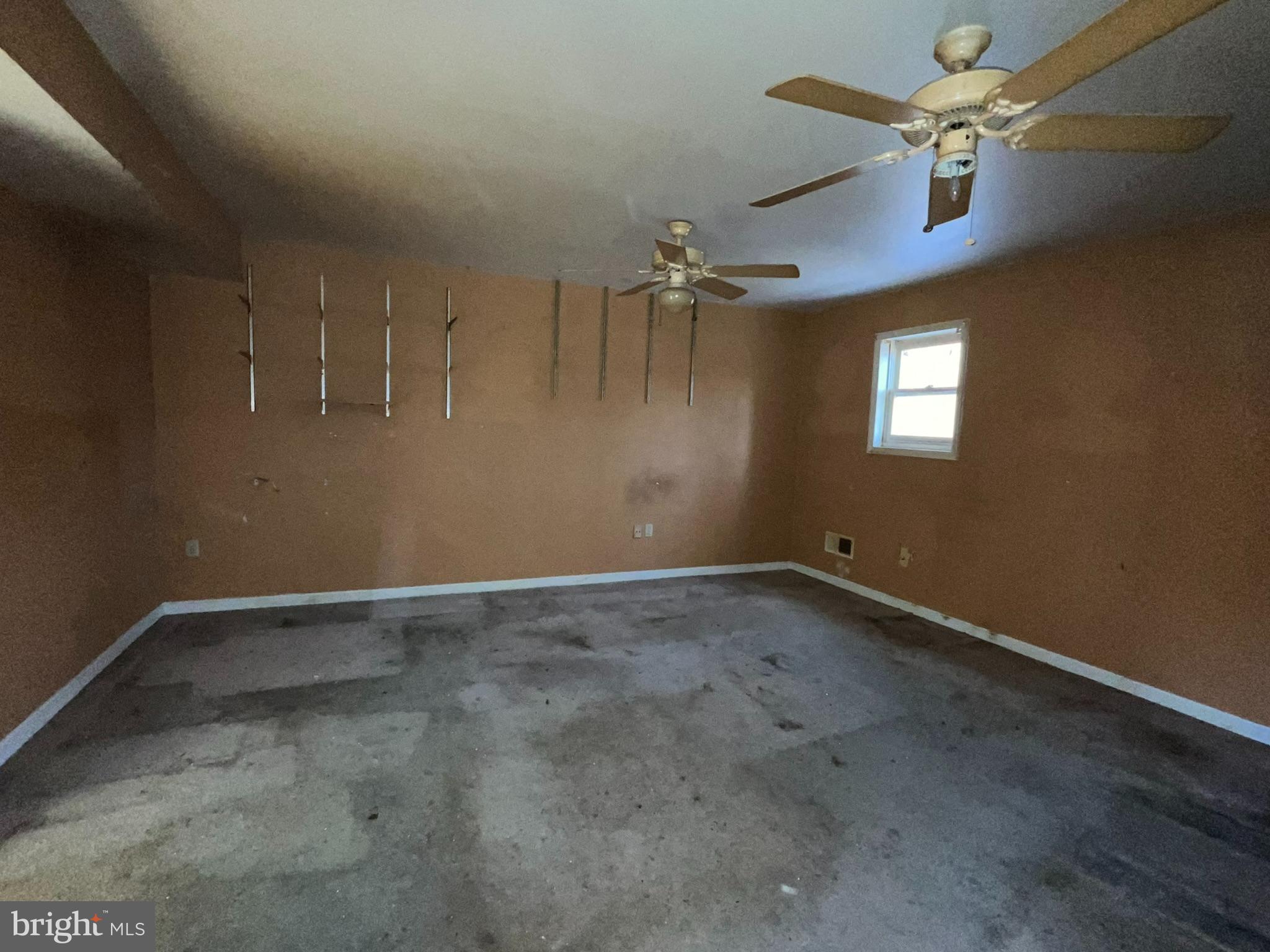 8520 Pine Boulevard Lusby, MD 20657 - Photo 7 of 13 an empty room with a ceiling fan and window