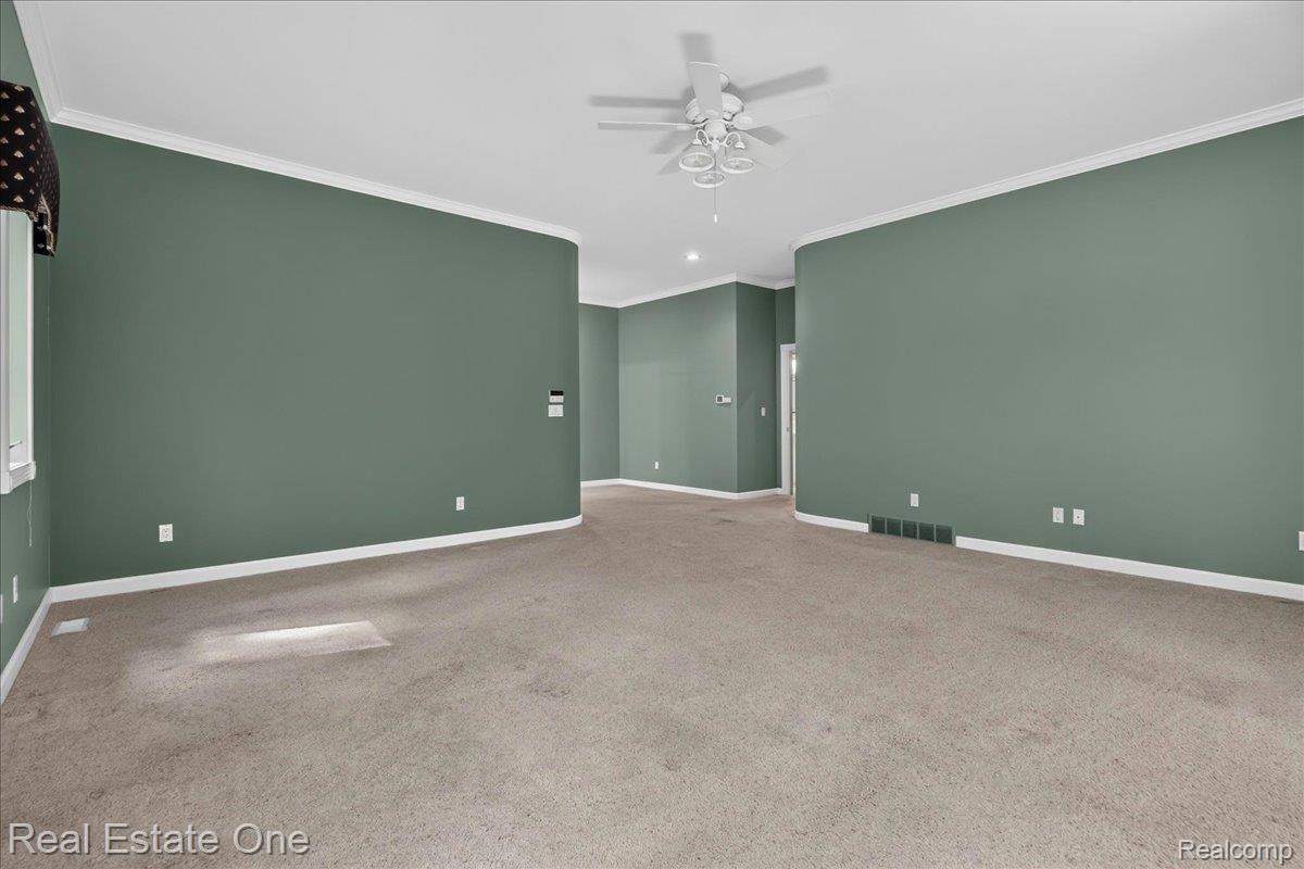 425 Courtney Road Leonard, MI 48367 - Photo 42 of 89 Spacious room featuring neutral carpeting and sage green walls