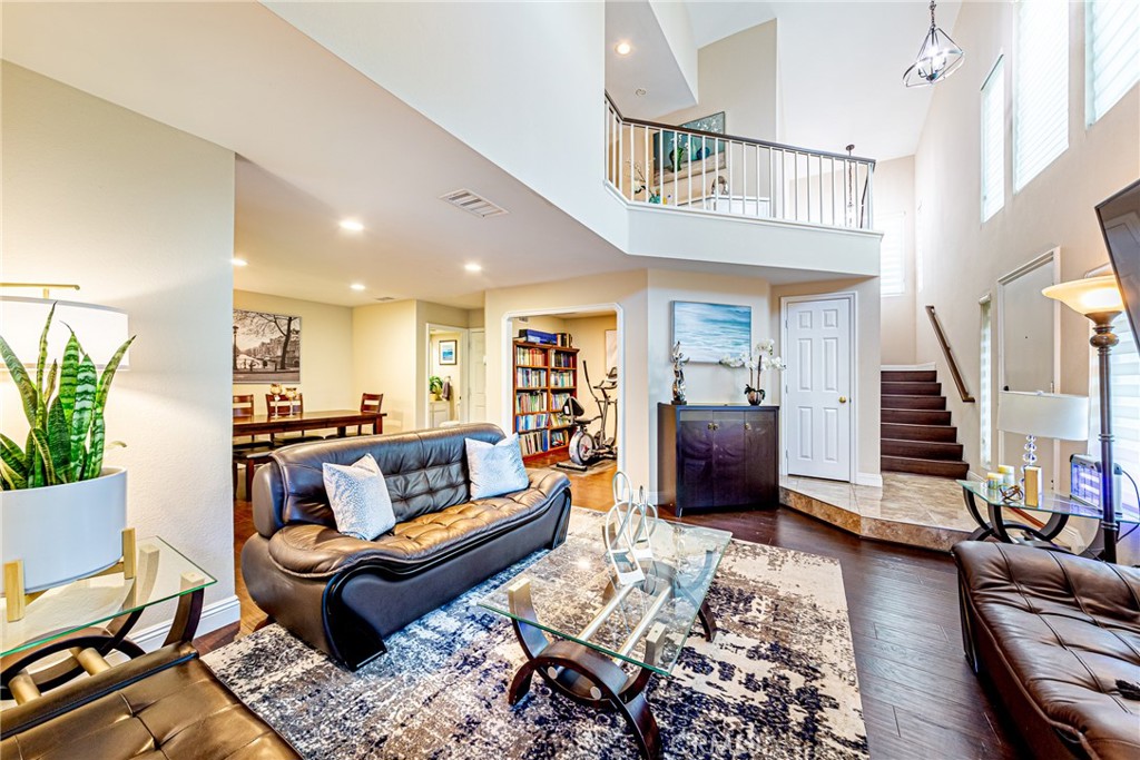 9271 Rancho Park Place Rancho Cucamonga, CA 91730 - Photo 1 of 1 a living room with furniture or stairs and a wooden floor