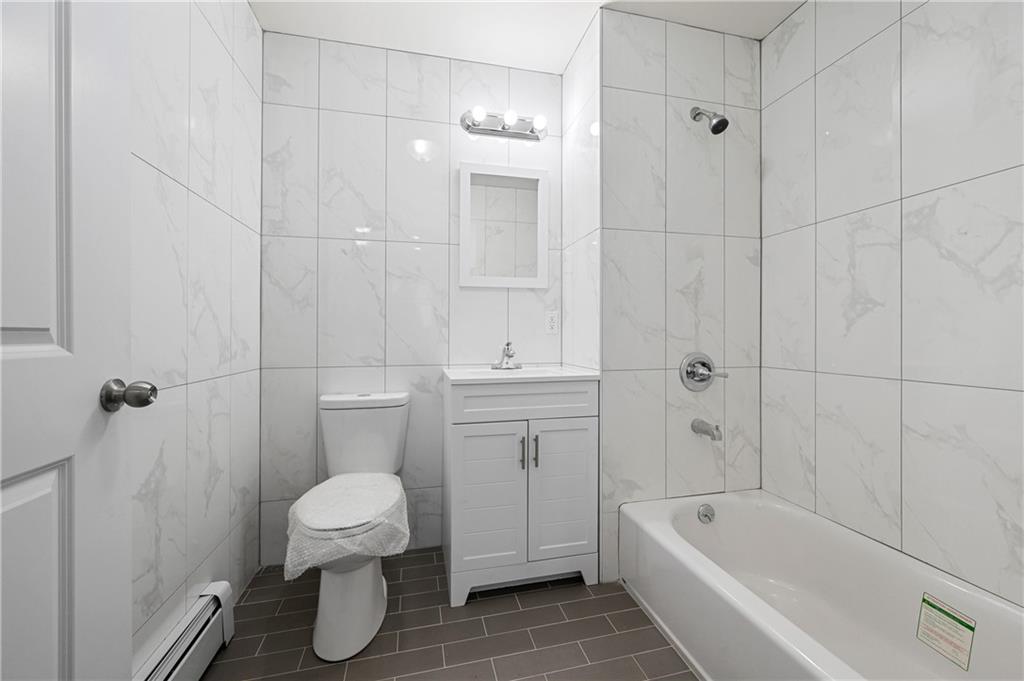 2167 West 13th Street Brooklyn, NY 11223 - Photo 12 of 35 a bathroom with a toilet and a bathtub