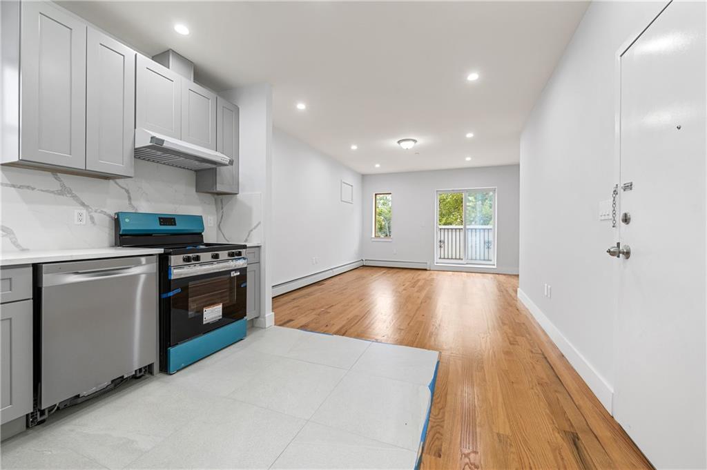 2167 West 13th Street Brooklyn, NY 11223 - Photo 14 of 35 a kitchen with stainless steel appliances granite countertop a stove and a refrigerator