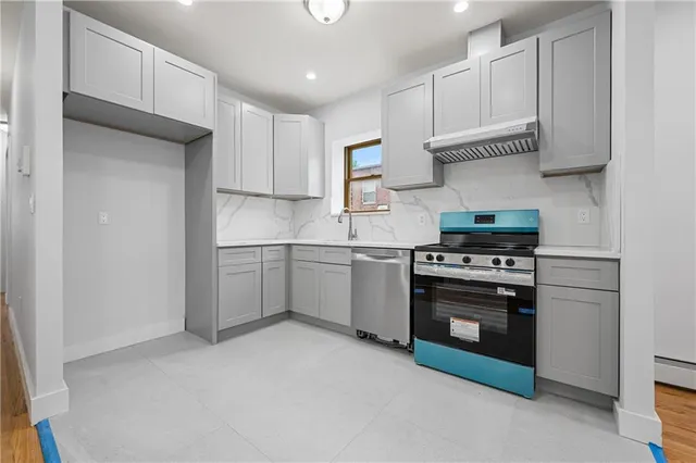 a kitchen with stainless steel appliances granite countertop a sink and a stove