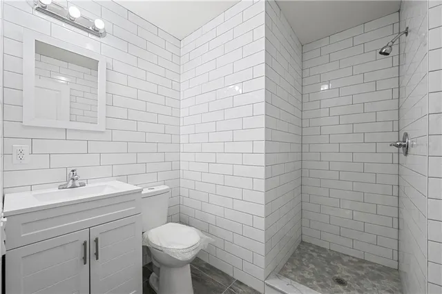 a bathroom with a toilet sink and shower