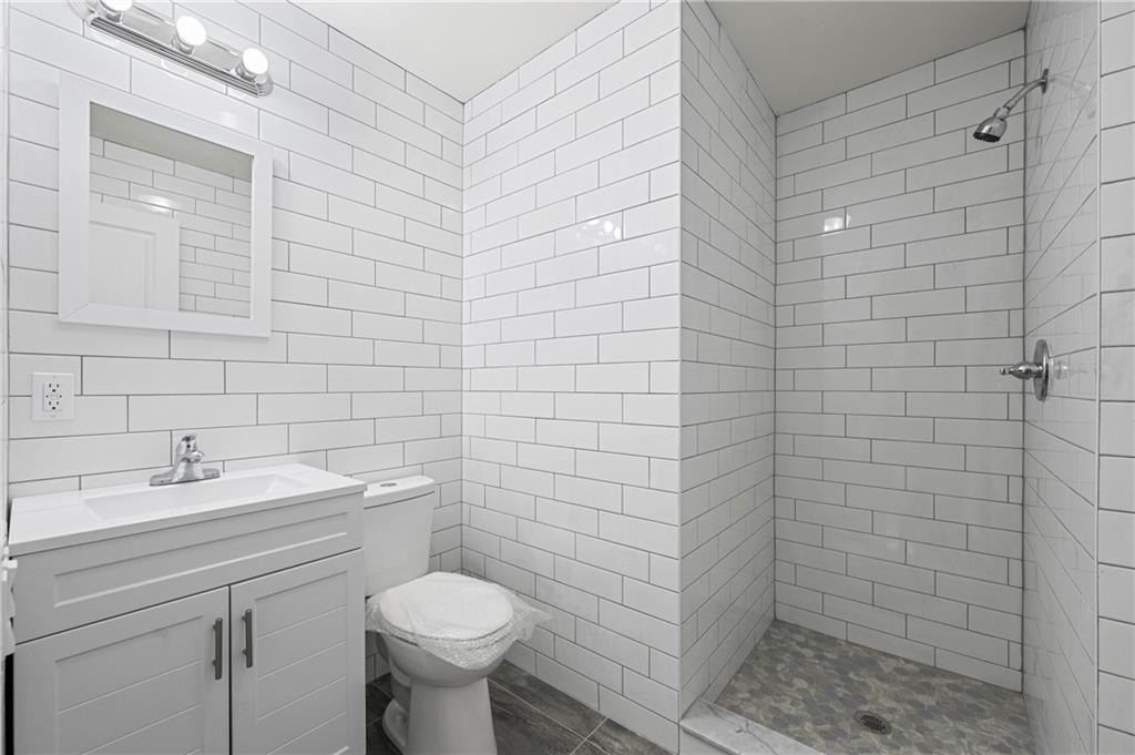 2167 West 13th Street Brooklyn, NY 11223 - Photo 19 of 35 a bathroom with a toilet sink and shower