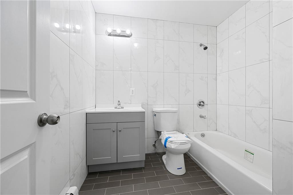 2167 West 13th Street Brooklyn, NY 11223 - Photo 20 of 35 a bathroom with a sink a toilet and shower