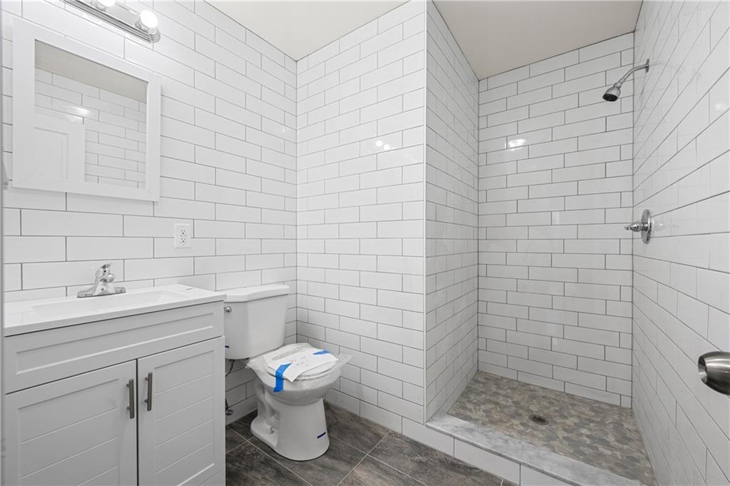 2167 West 13th Street Brooklyn, NY 11223 - Photo 29 of 35 a bathroom with a sink a toilet and shower
