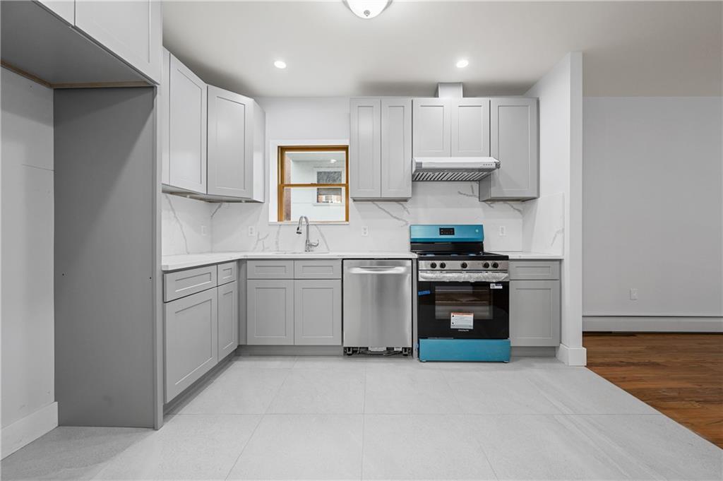 2167 West 13th Street Brooklyn, NY 11223 - Photo 5 of 35 a kitchen with a stove sink and cabinets