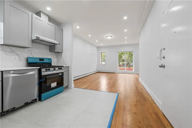 a view of kitchen with wooden floor electronic appliances and window
