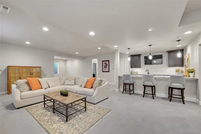 a living room with furniture and kitchen view