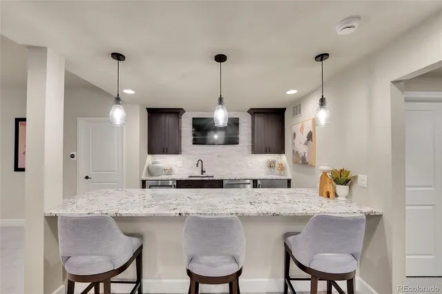 a kitchen with center island cabinets and chairs in it