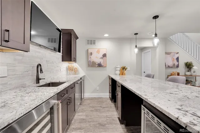 a kitchen with stainless steel appliances granite countertop a sink stove and cabinets