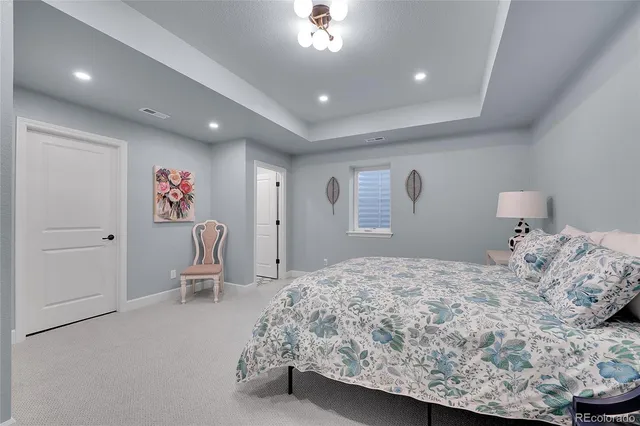 a bedroom with a bed and a chair