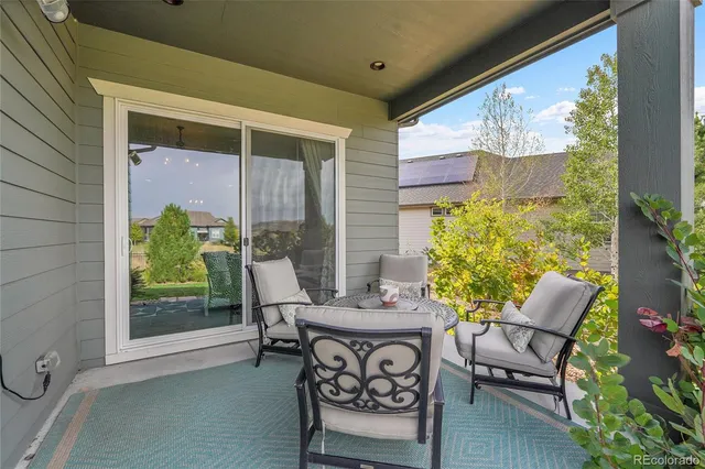 a view of a patio with a table chairs and a potted plant