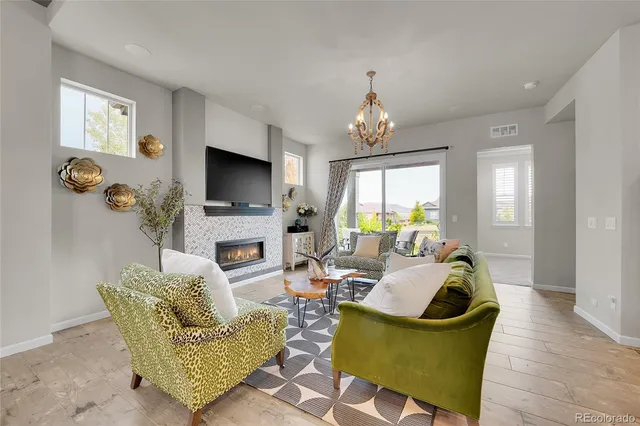 a living room with fireplace furniture and a flat screen tv