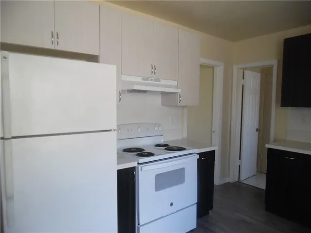 a kitchen with stainless steel appliances a refrigerator and cabinets
