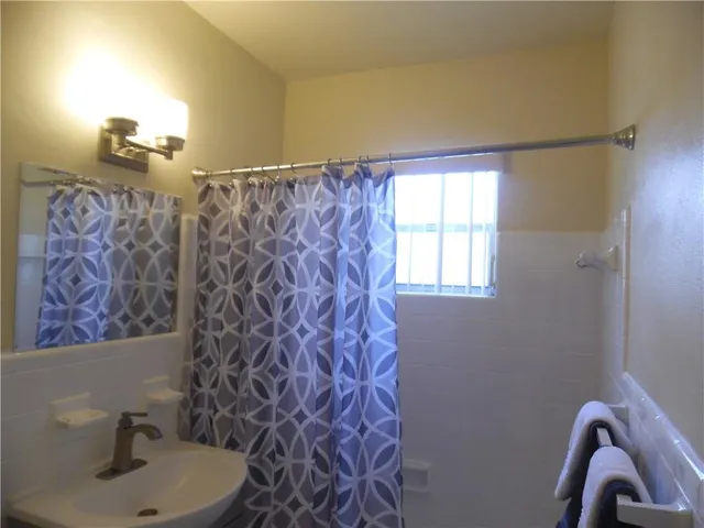 a bathroom with a sink mirror and vanity