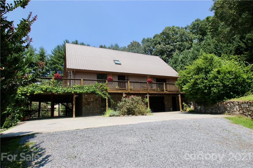 72 Slow Lane Canton, NC 28716 - Photo 2 of 47 a front view of a house with a yard and garage