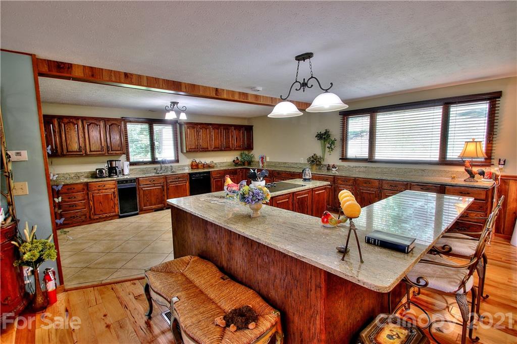 72 Slow Lane Canton, NC 28716 - Photo 12 of 47 a kitchen with stainless steel appliances granite countertop wooden cabinets a stove and a sink