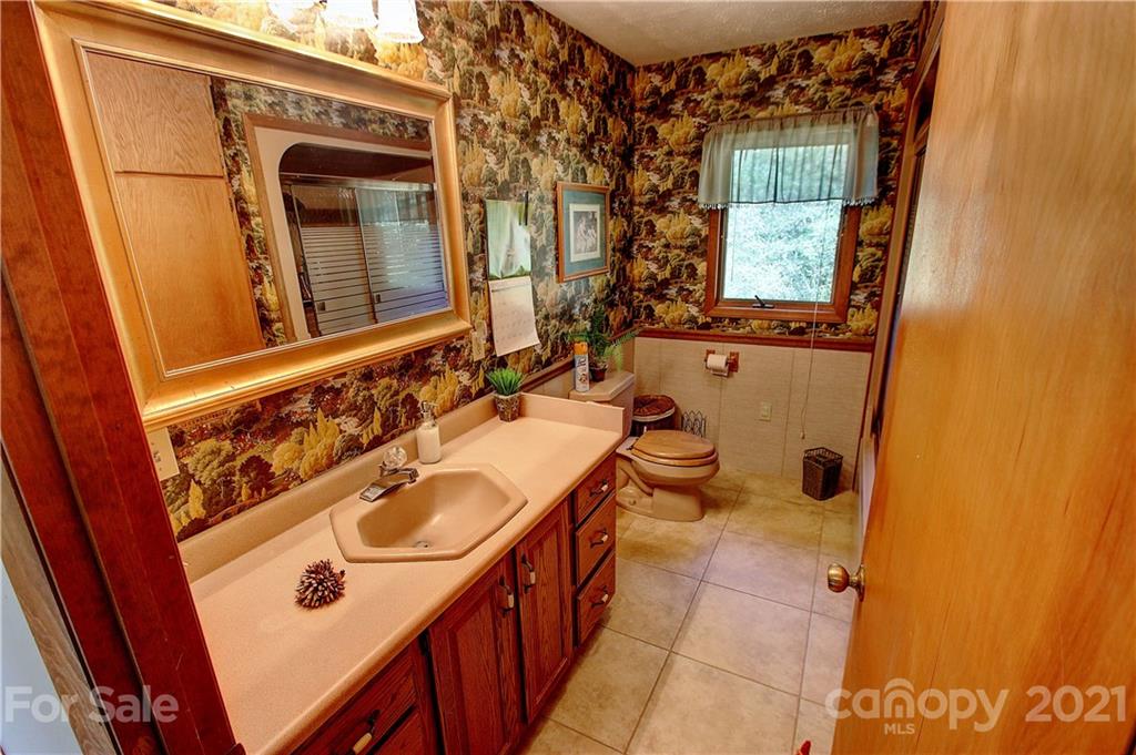 72 Slow Lane Canton, NC 28716 - Photo 14 of 47 a bathroom with a sink and a mirror