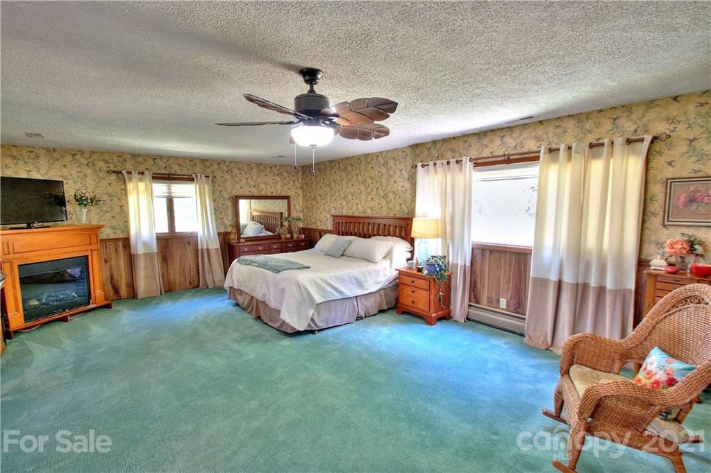 72 Slow Lane Canton, NC 28716 - Photo 15 of 47 a bedroom with a bed closet and flat tv screen