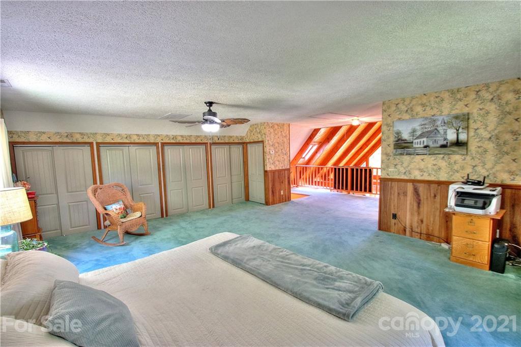 72 Slow Lane Canton, NC 28716 - Photo 17 of 47 a bedroom with furniture and a chandelier