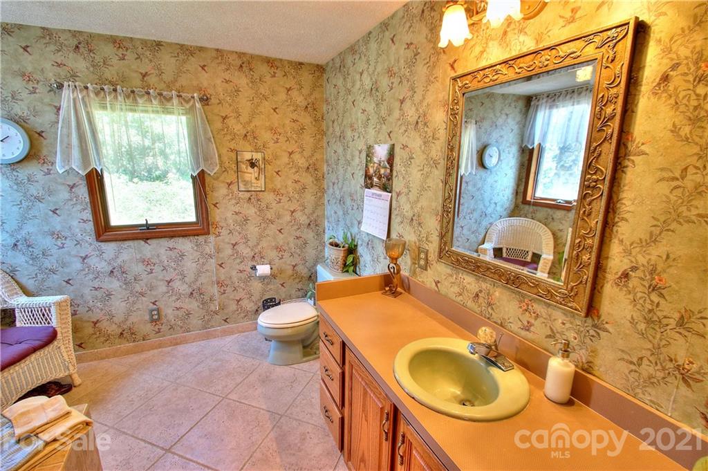 72 Slow Lane Canton, NC 28716 - Photo 18 of 47 a bathroom with a sink and a mirror