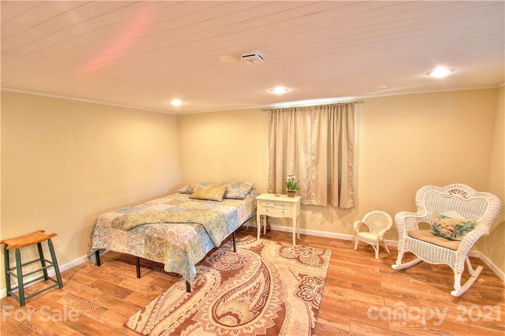 72 Slow Lane Canton, NC 28716 - Photo 23 of 47 a spacious bedroom with a bed and a table