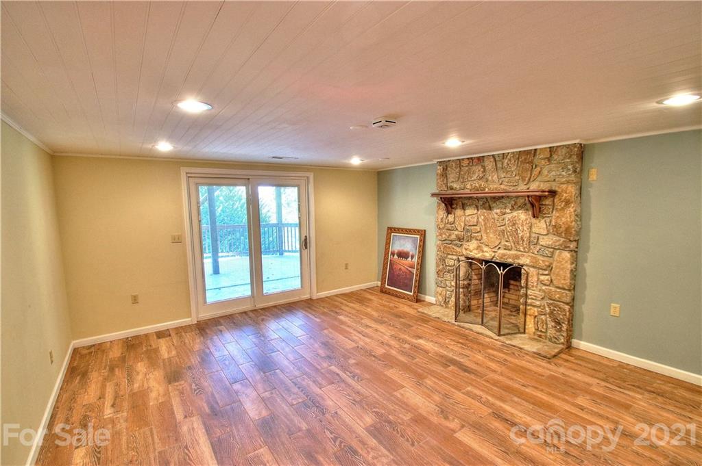 72 Slow Lane Canton, NC 28716 - Photo 24 of 47 a view of empty room with wooden floor and fireplace