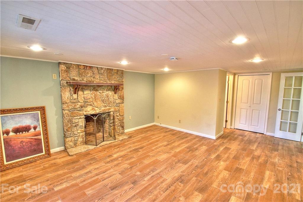 72 Slow Lane Canton, NC 28716 - Photo 25 of 47 a view of an empty room with a fireplace and a window