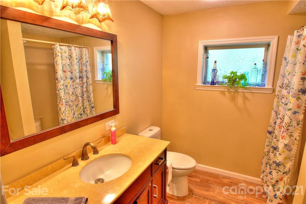 72 Slow Lane Canton, NC 28716 - Photo 26 of 47 a bathroom with a sink and a mirror