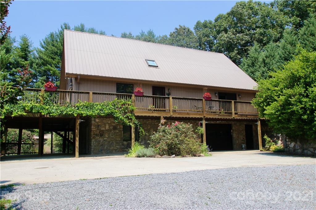 72 Slow Lane Canton, NC 28716 - Photo 27 of 47 a front view of a house with a yard and a garage