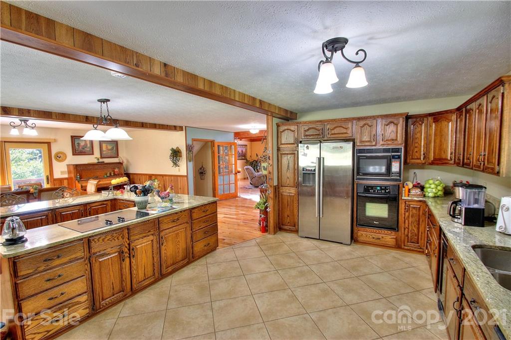 72 Slow Lane Canton, NC 28716 - Photo 10 of 47 a large kitchen with a large counter top appliances and cabinets