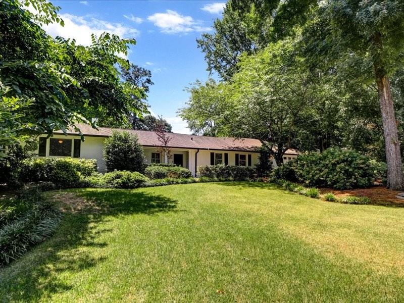 1241 Goodwin Road Northeast Atlanta, GA 30324 - Photo 1 of 1 a front view of a house with a yard