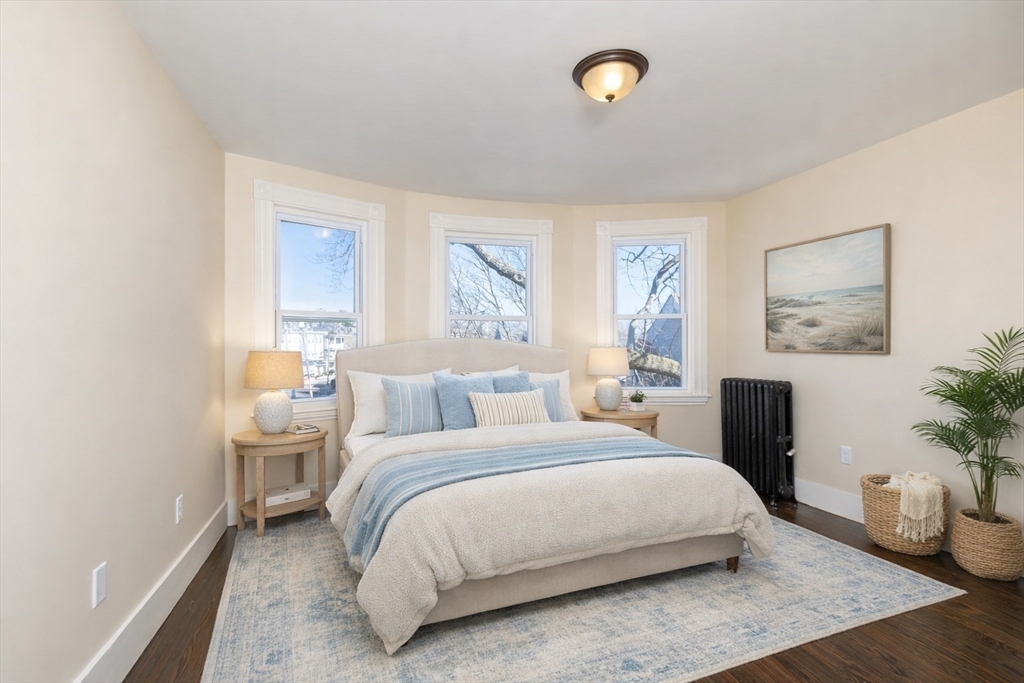 180 Shirley Street, Unit 3 Winthrop, MA 02152 - Photo 12 of 18 a bedroom with a large bed and a painting on the wall