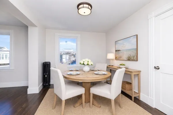 a view of a dining room with furniture and wooden floor
