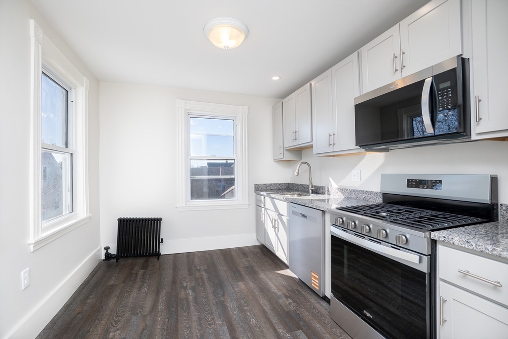 180 Shirley Street, Unit 3 Winthrop, MA 02152 - Photo 5 of 18 a kitchen with stainless steel appliances white cabinets and stove top oven