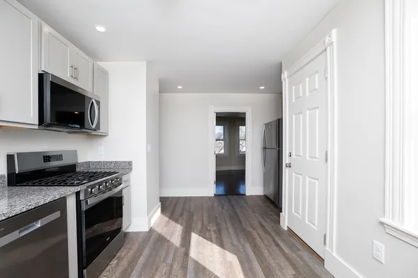 a kitchen with stainless steel appliances a refrigerator a stove top oven a sink and dishwasher