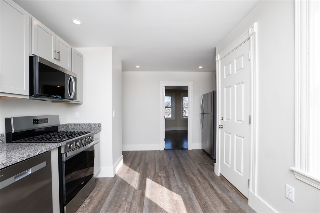 180 Shirley Street, Unit 3 Winthrop, MA 02152 - Photo 6 of 18 a kitchen with stainless steel appliances a refrigerator a stove top oven a sink and dishwasher
