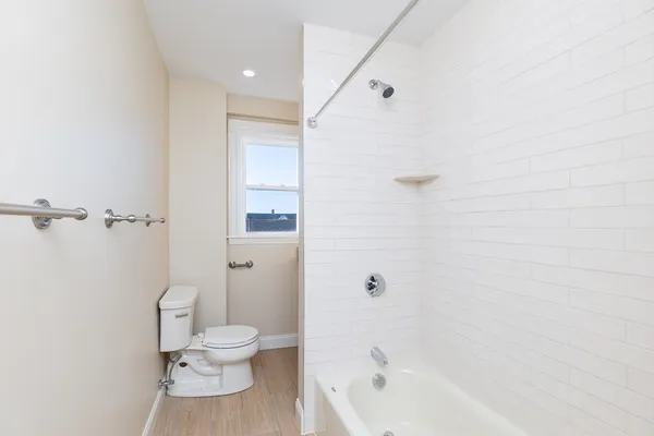 a bathroom with a toilet and a shower