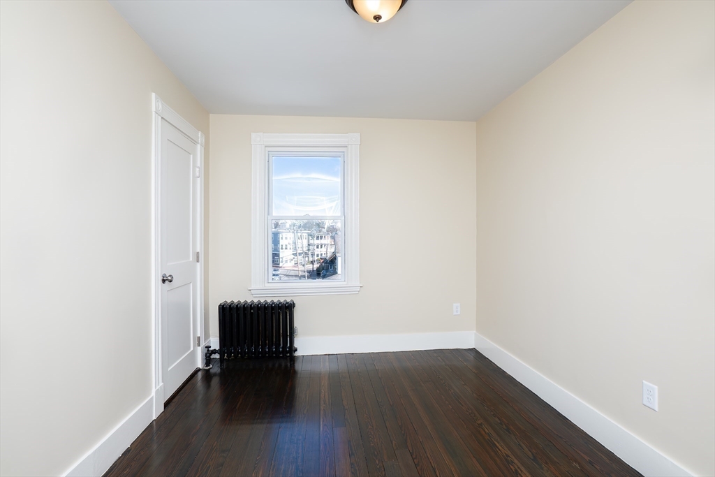 180 Shirley Street, Unit 3 Winthrop, MA 02152 - Photo 10 of 18 a view of room with window and wooden floor