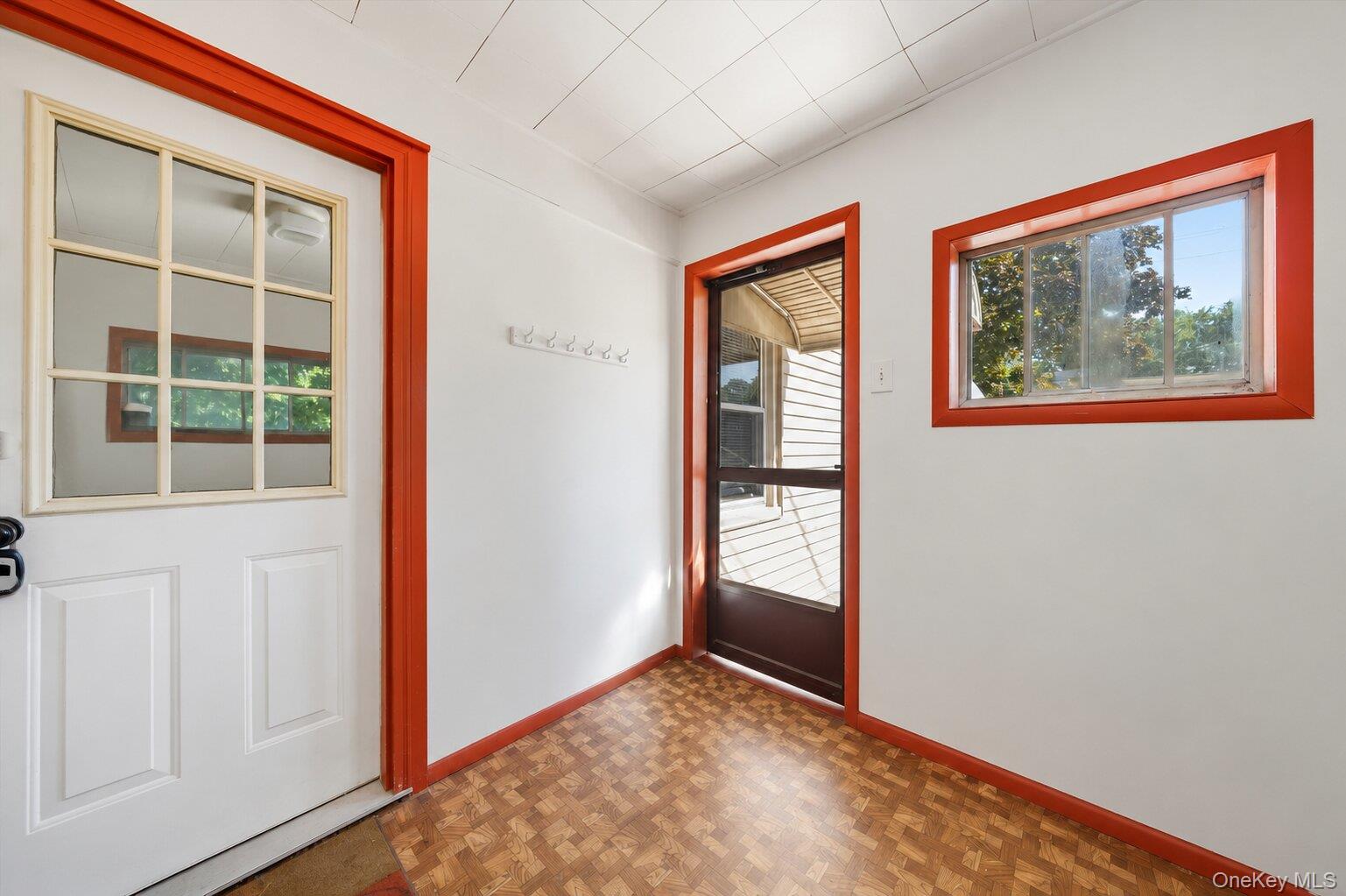 49 Chase Road Wallkill, NY 12589 - Photo 26 of 32 Bonus Room: Bright bonus room with built-in cabinets, mirrored storage, distinctive red trim, and flexible space for an office, craft room, or playroom.