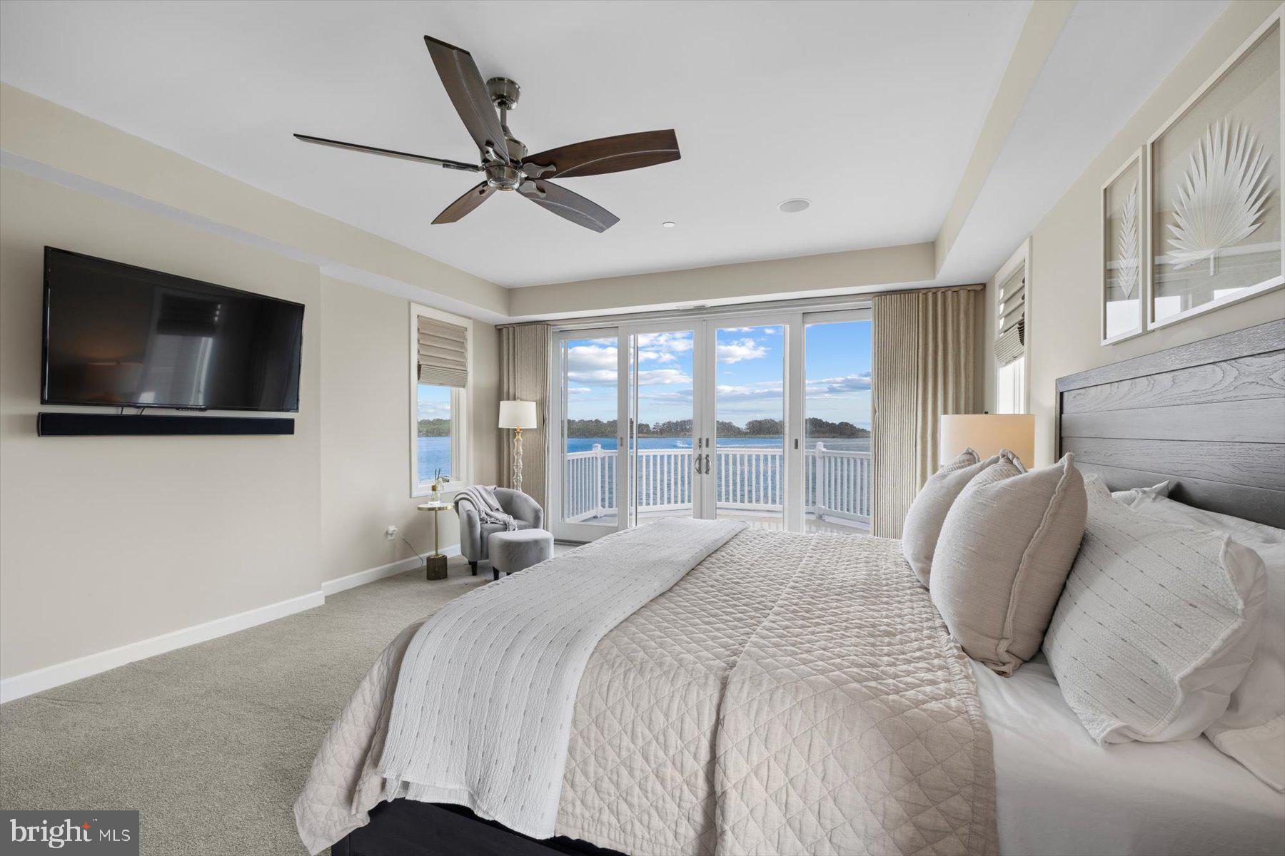 35 Inlet View Court Bethany Beach, DE 19930 - Photo 30 of 74 a bedroom with a bed a flat screen tv and a large window