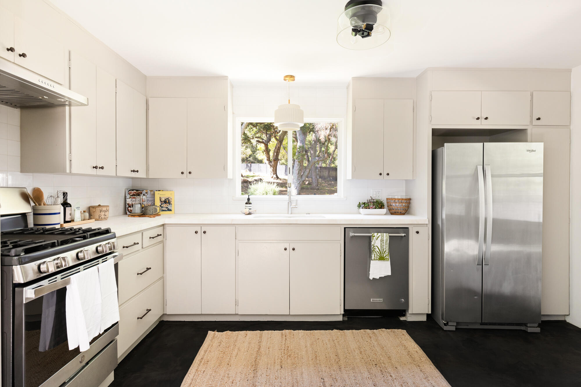 2070 East Valley Road Montecito, CA 93108 - Photo 12 of 34 a kitchen with white cabinets and white appliances