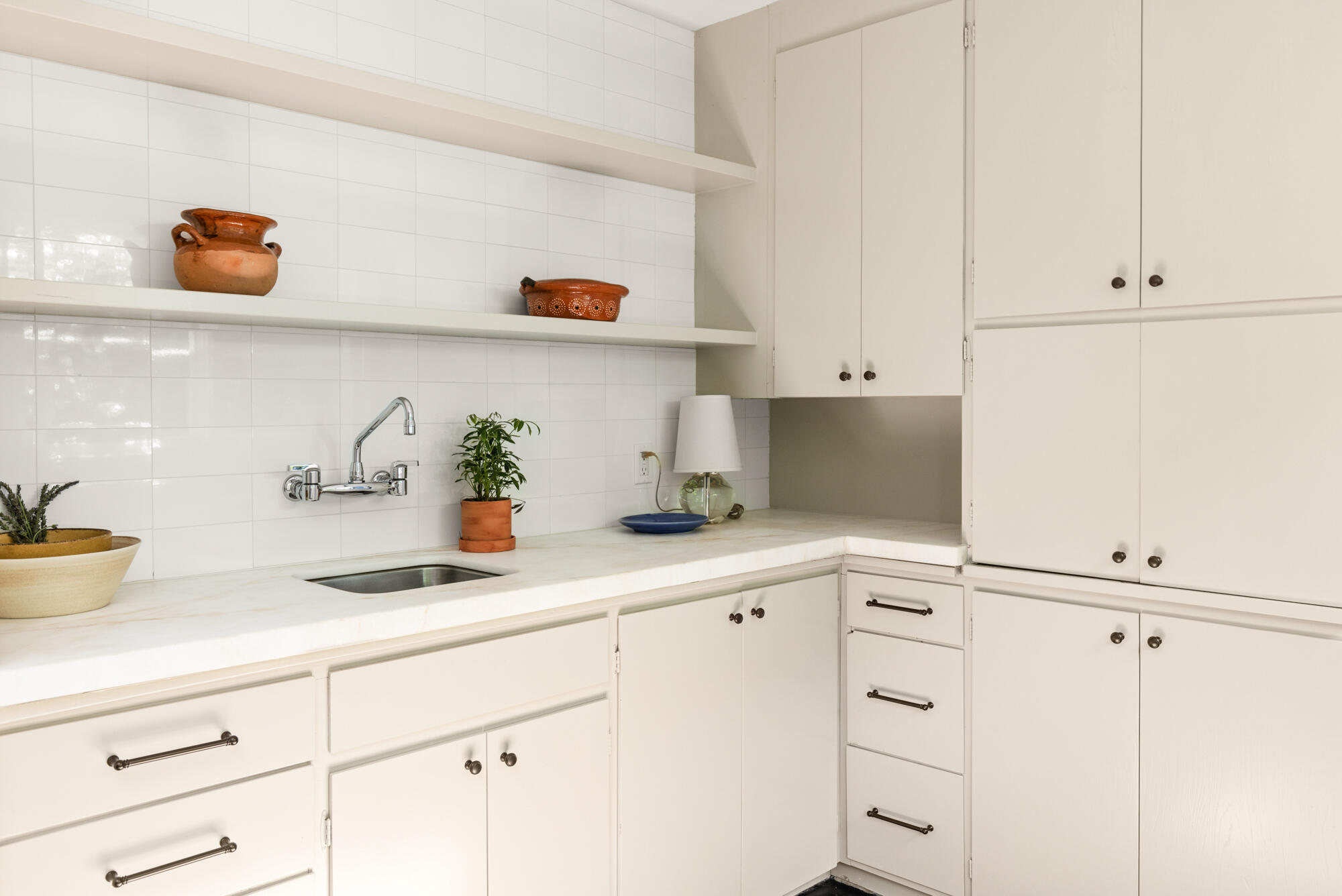 2070 East Valley Road Montecito, CA 93108 - Photo 14 of 34 a kitchen with white cabinets and a sink