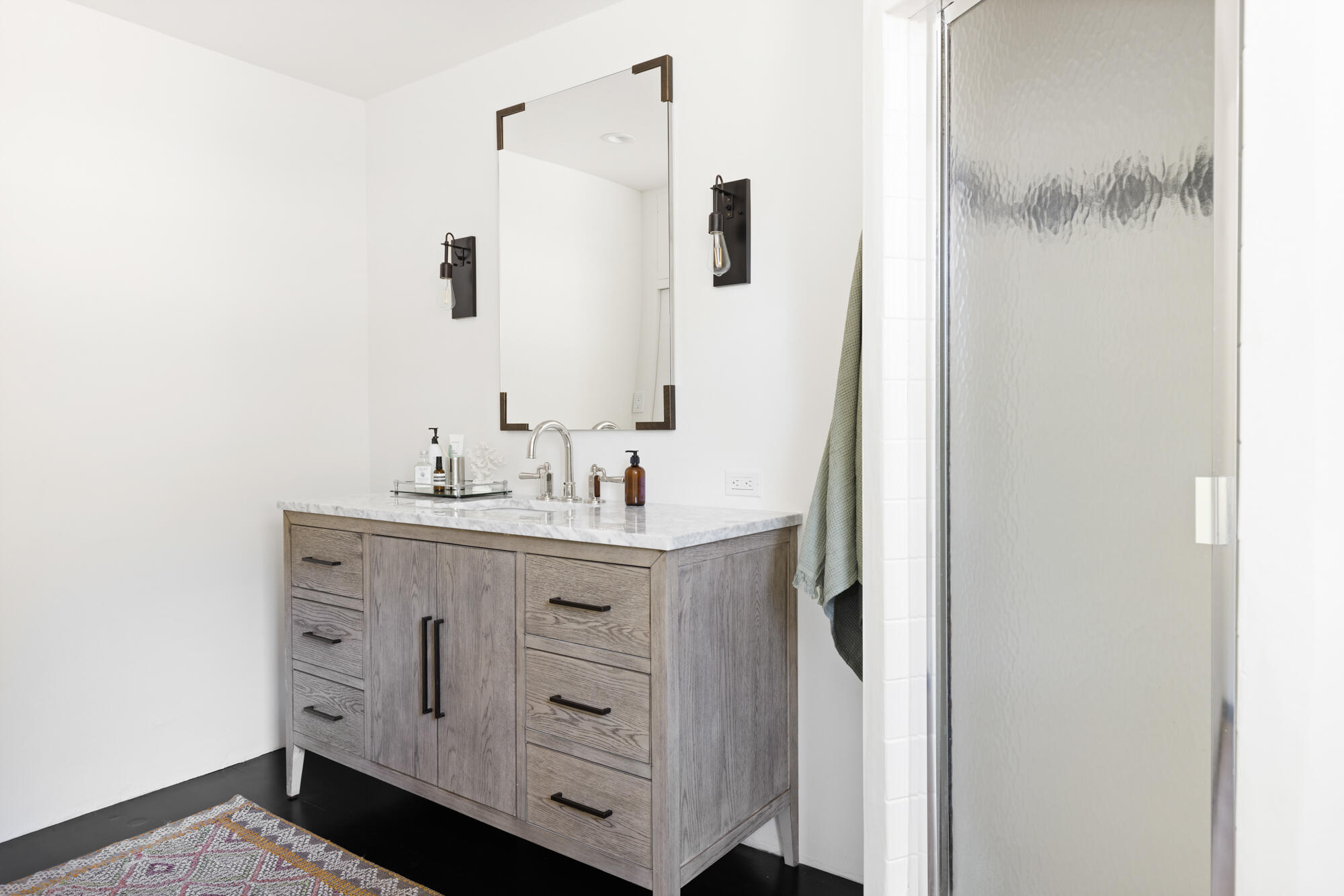 2070 East Valley Road Montecito, CA 93108 - Photo 17 of 34 a bathroom with a double vanity sink and mirror