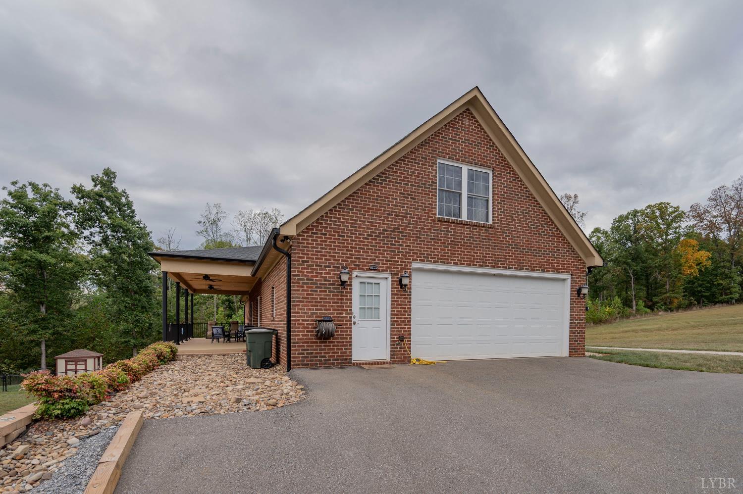 1080 Tranquility Lane Goode, VA 24556 - Photo 29 of 65 a front view of a house with a yard and garage